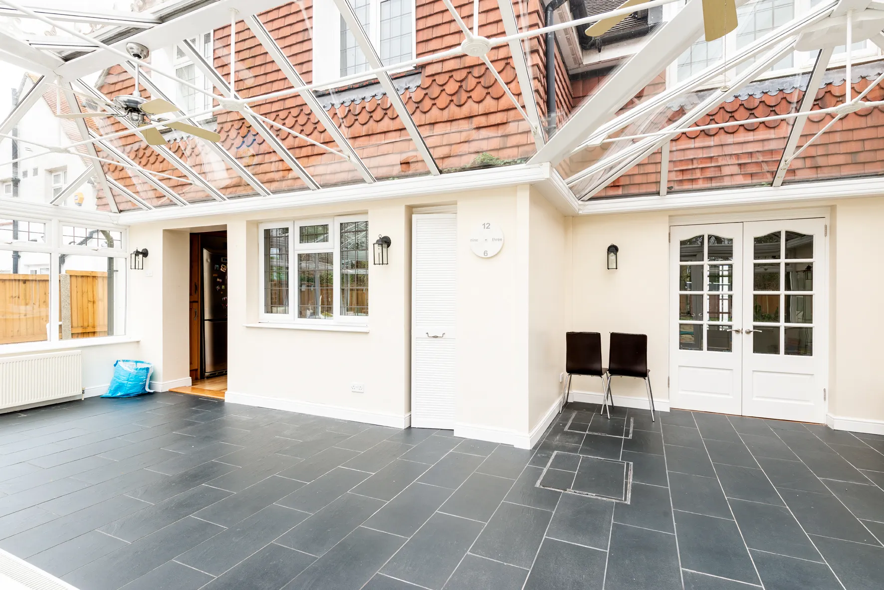 A room with a tiled floor and a glass roof.