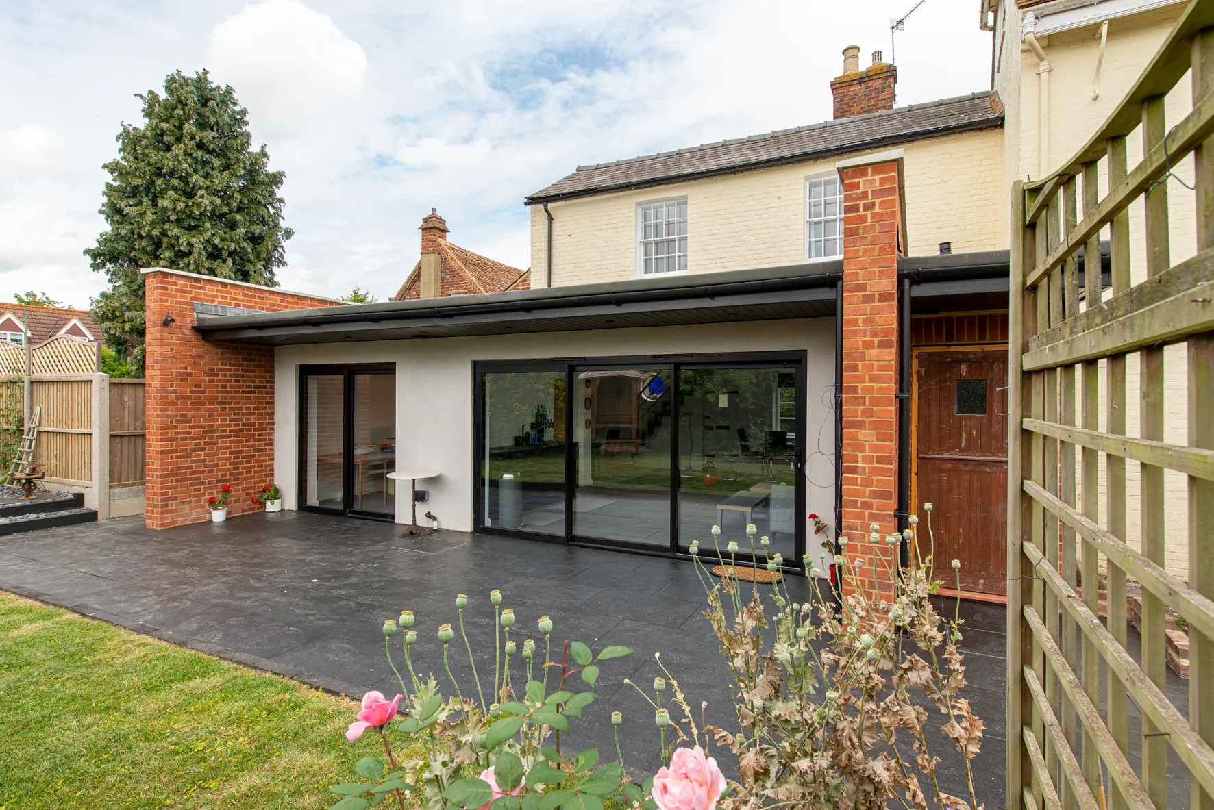 A house with a large patio and a brick wall.